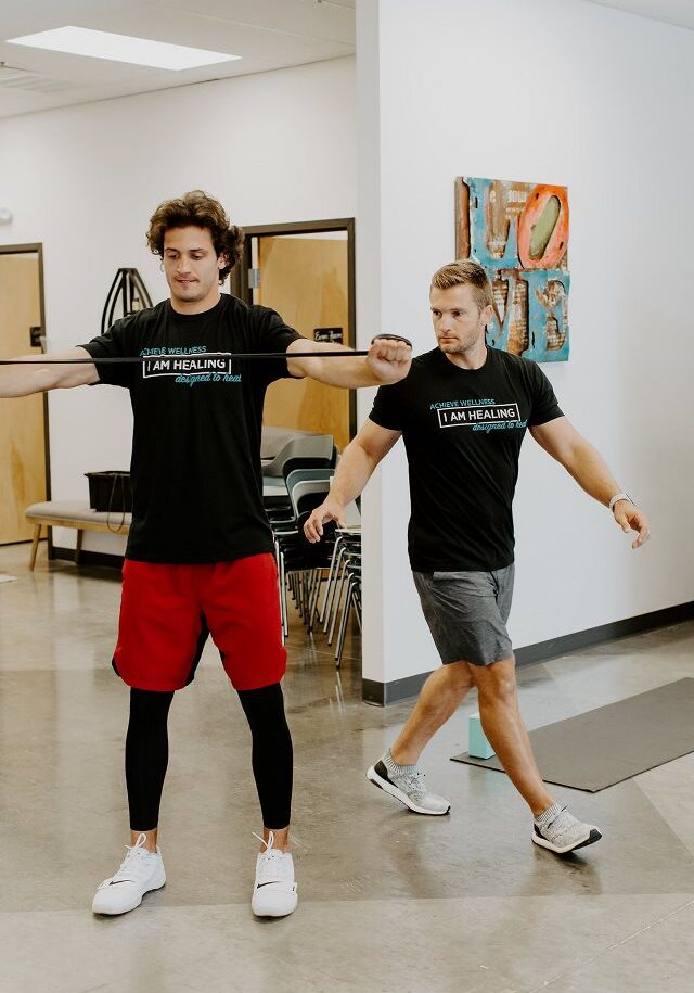 Ryne Malone observing a fitness trainee while they work out